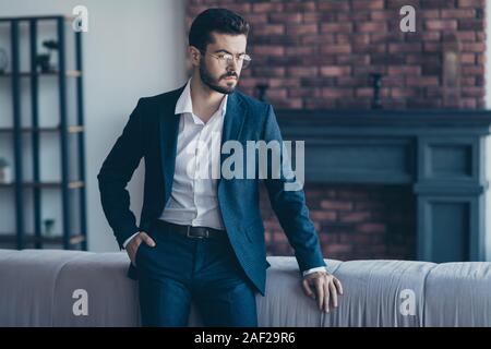 Portrait of his he nice attractive serious imposing bearded guy ceo boss chief top director waiting meeting at modern industrial loft interior work Stock Photo