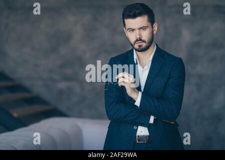 Portrait of his he nice attractive serious smart clever bearded guy top director lawyer attorney experienced shark at modern industrial interior gray Stock Photo