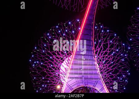 bottom view at pink Supertree during the nightly Musical Lights Show in the Gardens By The Bay in Singapore Stock Photo