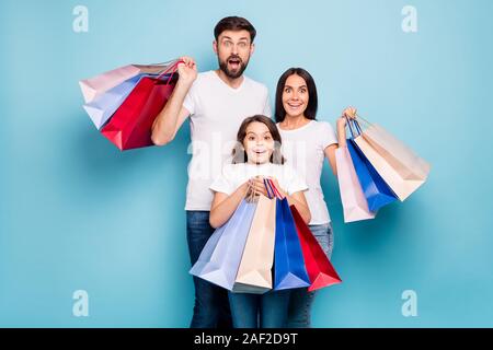 50 off. Real bargain concept. Portrait of excited three people mom dad schoolkid shop center hold bags scream wow omg wear white t-shirt denim jeans Stock Photo