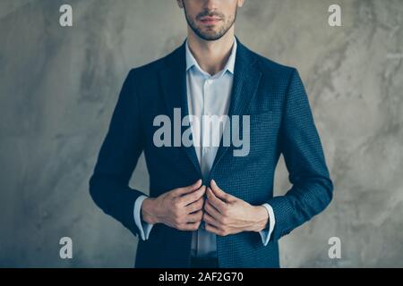 Cropped photo of white clever business people standing confidently fastening his blazer with stubble on face isolated grey color background Stock Photo