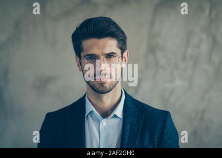 Close up photo of confident serious man in eye glasses with stubble staring into camera isolated grey color background Stock Photo