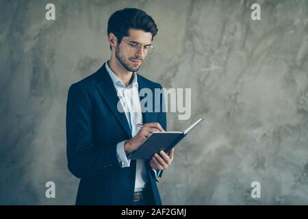 Photo of concentrated man stubble writing down after employee to be accepted in eyewear eye glasses isolated grey color background Stock Photo