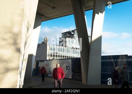 People walking past the site of the old Post Office building being demolished as part of the long awaited redevelopment of Basildon Town centre in Ess Stock Photo