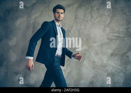 Photo of serious confident executive director with stubble moving forward in formal wear eye glasses eyewear spectacles isolated grey color background Stock Photo