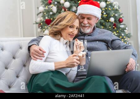Positive delighted bearded man embracing his wife Stock Photo