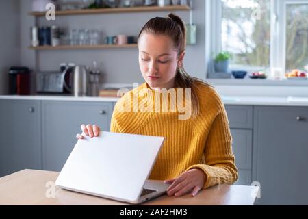 Woman Concerned About Excessive Use Of Internet Closing Lid Of Laptop Computer Stock Photo