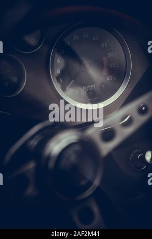 Color close up shot of a tachometer on a vintage car's dashboard. Stock Photo