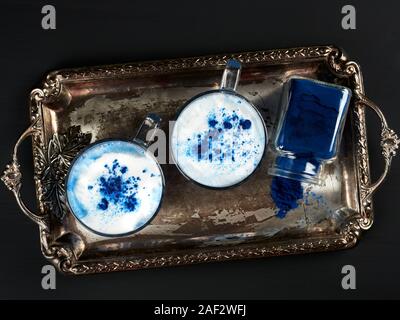 A blue latte colored with natural phycocyanin extracted from blue spirulina algae, flat lay Stock Photo