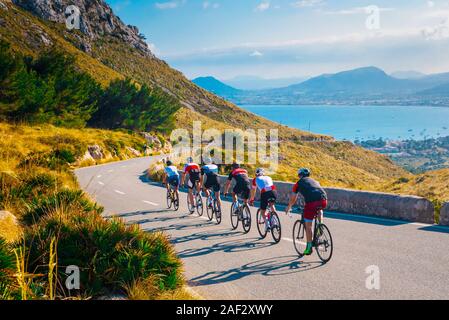 Sporty friends on bicycle on sunset light in beautiful nature by the sea. Road cycling on the coast. Sport in Nature background Teamwork concept photo Stock Photo