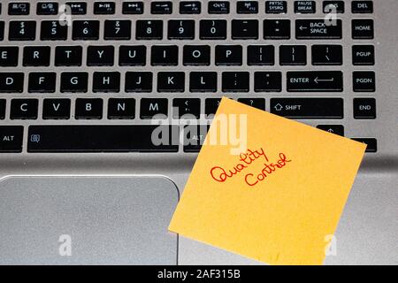Quality Note Sticker QUALITY CONTROL text on sticker on blue background with pen and ...