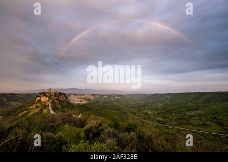 Panoramic view of Civita di Bagnoregio, an old etruscan settlement, located on top of a volcanic tuff plateau, with a rainbow Stock Photo