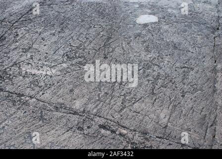 Petroglyph Primitive drawings on stones. Ancient art by prehistoric humans. Stock Photo