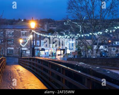 Fairy lights on the bridge and the High Street at Pateley Bridge at Christmas Nidderdale AONB North Yorkshire England Stock Photo