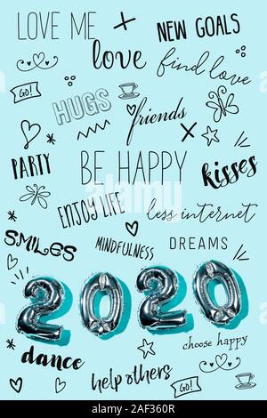 some silvery number-shaped balloons forming the number 2020, as the new year, and some new year resolutions on a blue background Stock Photo