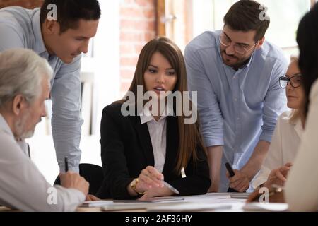 Businesspeople working together on project lead by team leader businesswoman Stock Photo