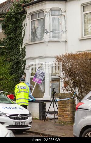 Westcliff on Sea, UK. 12th Dec, 2019. Police and forensic teams investigate a murder scene on Tintern Avenue, Westcliff-on-Sea, Essex. The residential property is cordoned off with crime scene tape. Officers in high-visibility jackets and forensic investigators in protective suits document evidence outside the house. A tripod-mounted camera is positioned near the front window. A “CRIME SCENE DO NOT ENTER” sign is visible. Penelope Barritt/Alamy Live news. Stock Photo
