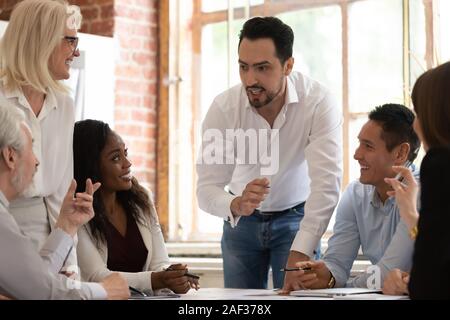 Multicultural coworkers working on project together at meeting in office Stock Photo