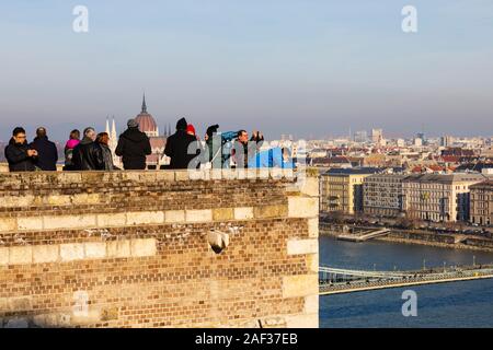 Tourists look out over the River Danube from Buda Castle, Winter in Budapest, Hungary. December 2019 Stock Photo