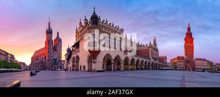 Panorama of Medieval Main market square with Basilica of Saint Mary, Cloth Hall and Town Hall Tower in Old Town of Krakow at sunrise, Poland Stock Photo