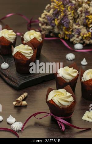 Homemade cupcakes with cream on a dark background, Concept for Valentine's Day, Birthday and Father's day Stock Photo