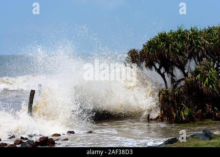 Big waves crushing on shore of a tropical island trees during a storm. Stormy sea weather. Power in nature background. Taken before severe cyclone hit Stock Photo