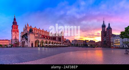 Panorama of Medieval Main market square with Basilica of Saint Mary, Cloth Hall and Town Hall Tower in Old Town of Krakow at sunrise, Poland