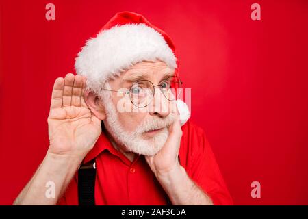 Close-up portrait of his he nice stunned amazed curious suspicious bearded Santa Claus trying to overhear what you say isolated over bright vivid Stock Photo