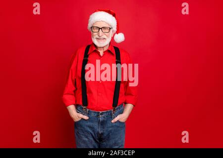 Portrait of his he nice trendy cheerful kind content bearded Santa Claus wearing eyewear holding hands in pockets isolated over bright vivid shine Stock Photo