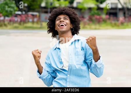 African american hipster young adult freaking out outdoor in summer in city Stock Photo