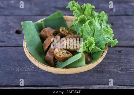 Sai Aua ( Northern Thai Spicy Sausage ) on the banana leaf plate Stock Photo