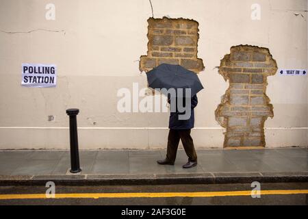 London, UK. 12th Dec, 2019. A man passes by a polling station for the general election in London, Britain on Dec. 12, 2019. Millions of voters on Thursday flocked to cast their ballots in Britain's third election in less than five years as polling stations opened across the country at 7:00 a.m. (0700 GMT). Credit: Tim Ireland/Xinhua/Alamy Live News Stock Photo