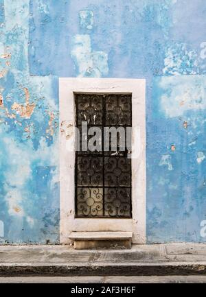 Faded, run-down blue wall of a colonial building in need of refurbishment in Campeche, Yucatan, Mexico. Stock Photo