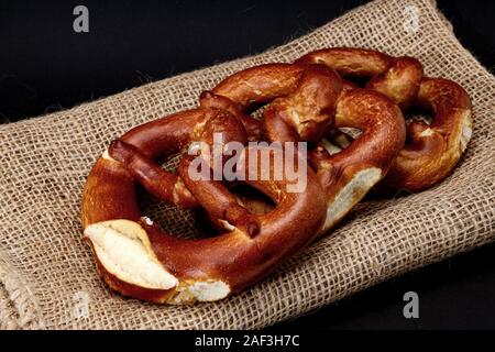 Pretzels on a hessian place mat - black background Stock Photo