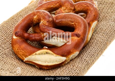 Pretzels on a hessian place mat - white  background Stock Photo