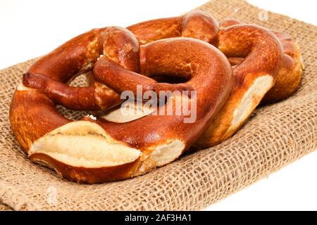 Pretzels on a hessian place mat - white  background Stock Photo