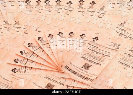 London, United Kingdom - May 7th, 2017 : UK National Lottery  tickets fanned out optimistically on a background of lottery tickets.  The National Lott Stock Photo