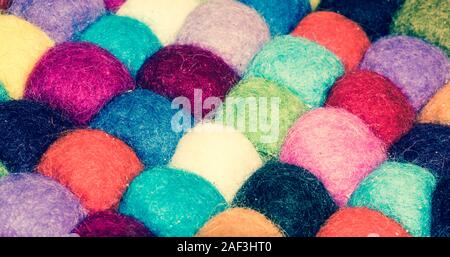 A lot of multi-colored balls of cotton for knitting close-up. Colored skeins of thread for needlework. Selective focus image. Stock Photo