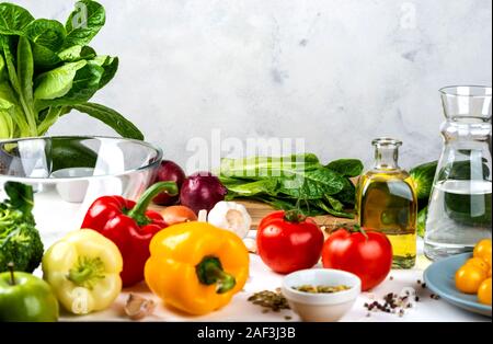 Different vegetables and spices, romaine lettuce on the board. Salad Ingredients on the table. Healthy diet vegan food concept. Stock Photo
