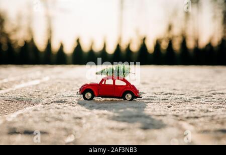 beetle car with Christmas tree on top parked in the snow Stock Photo