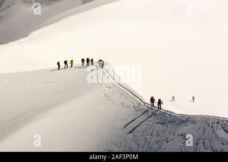 Climbers on the arete leading up from the Vallee Blanche to the Aiguille Du Midi above Chamonix, France. Stock Photo