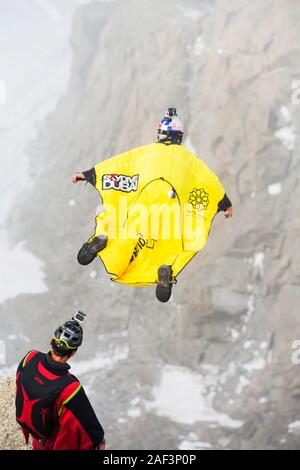 Base jumpers wearing wing suites jump from the Aiguille Du midi above Chamonix, France. Stock Photo