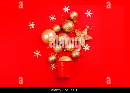 Beautiful festive red background with sparkles and Christmas golden toys. Holiday Content. New year 2020 Stock Photo