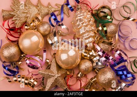 Beautiful festive purple background with sparkles and Christmas golden toys. Holiday Content. New year 2020 Stock Photo