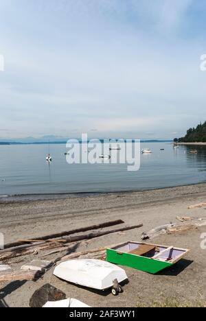 Small boats and pleasurecraft on the water and on the beach in West Seattle. Stock Photo