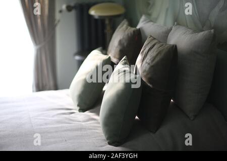 A set of pillows on a large wide bed in the bedroom Stock Photo