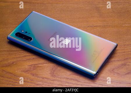PIATRA NEAMT, ROMANIA - NOVEMBER 25, 2019: Samsung Galaxy Note 10 on the desk, back side of the phone with camera module Stock Photo
