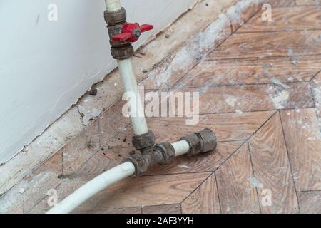 Old used dismantled fitting, faucet and plastic pipes Stock Photo