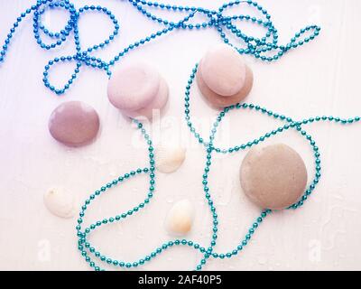 pile of stones, shells and sea star closeup on white background Stock Photo