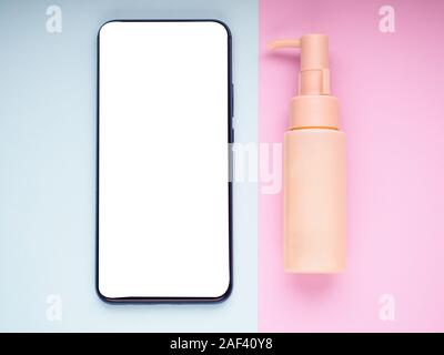 Mock up blank empty smart phone screen on pink beige fashion cosmetic feminine accessory gifts sale flat lay background, online app shopping in mobile Stock Photo